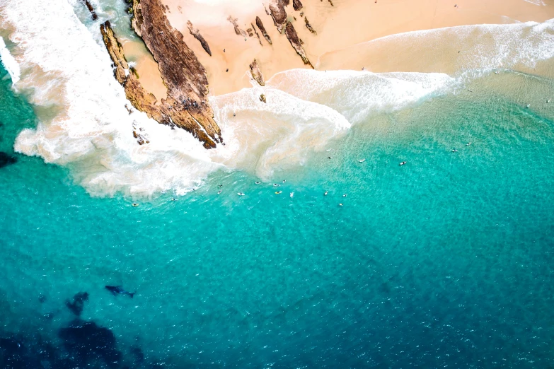 an aerial po of a sandy beach and some clear water