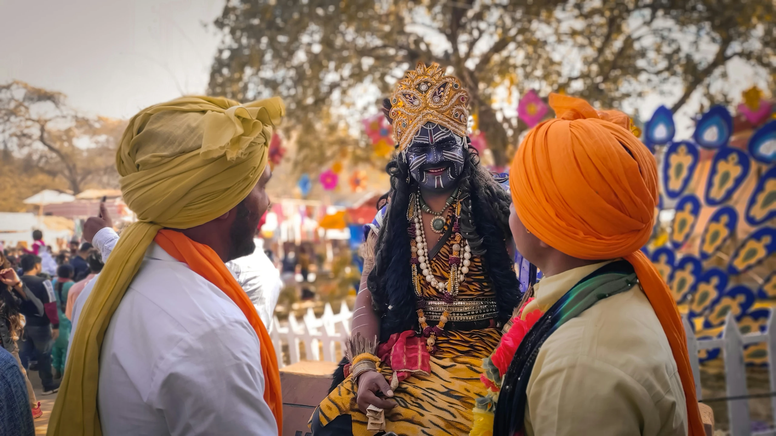 a man dressed in a costume standing next to two women