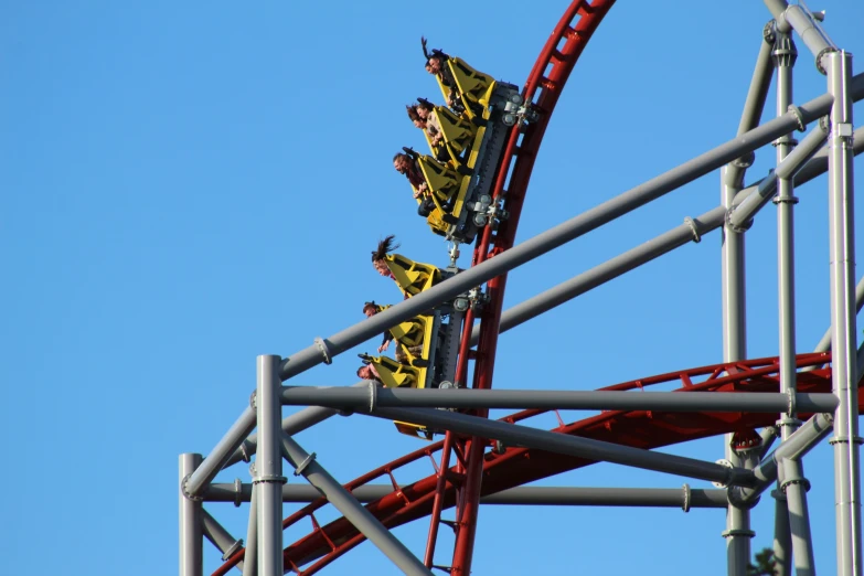 a roller coaster in a amut park on a clear day