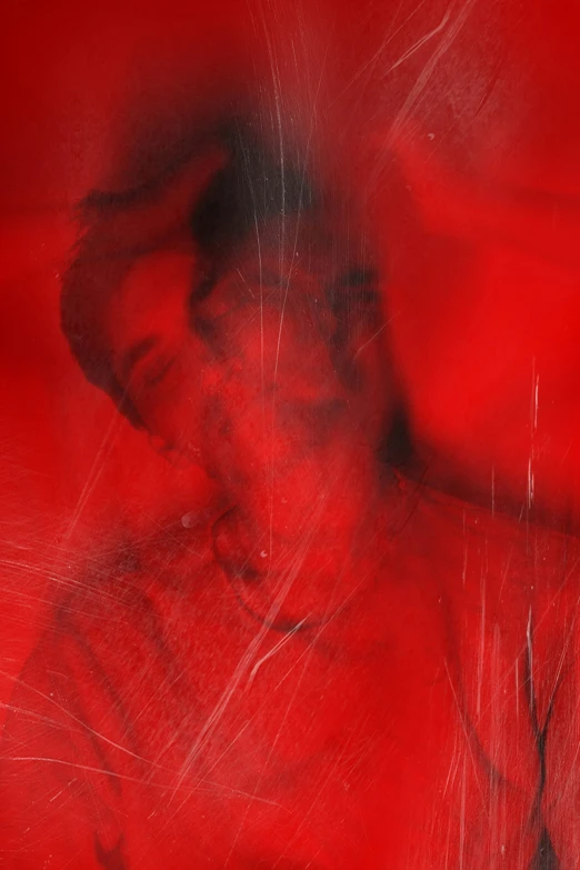 an artistic po of a man with red blurry colors
