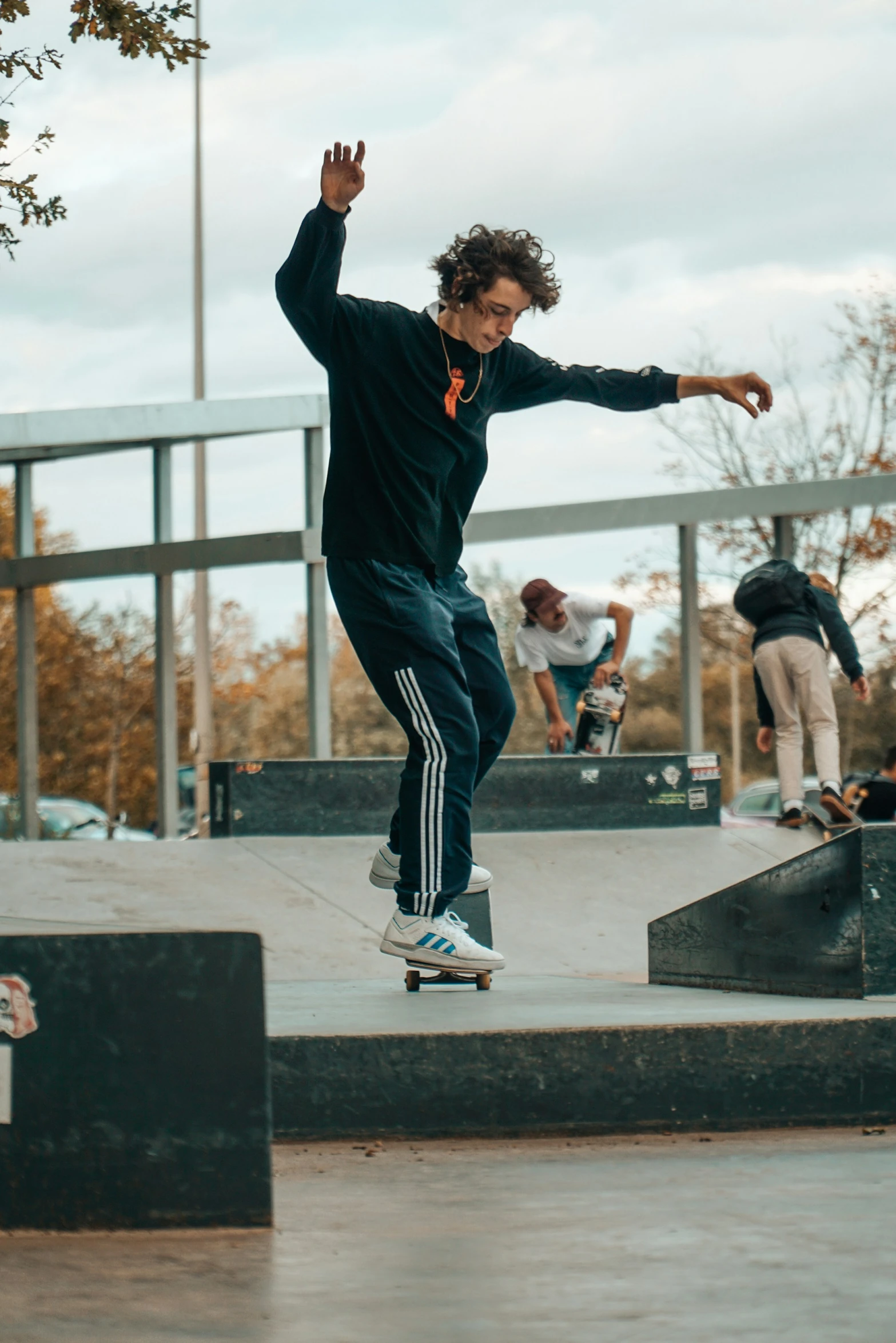 a skateboarder jumps down a small flight of stairs