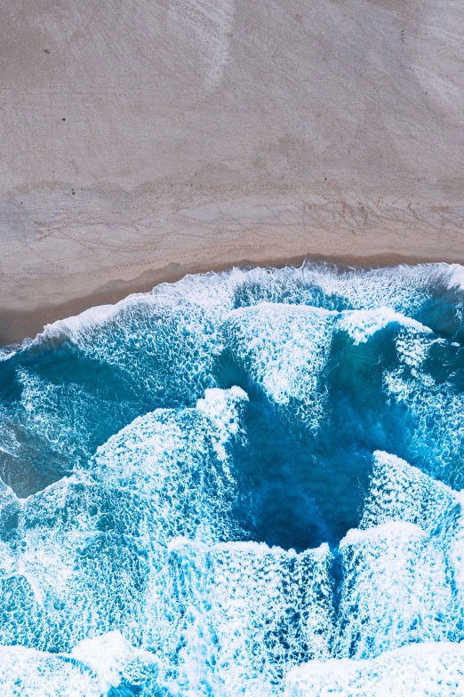 top view of blue ocean next to beach