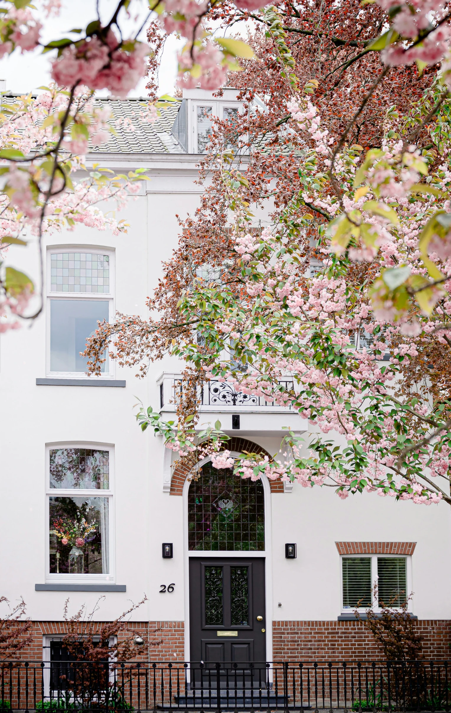 a white two story building with a black front door