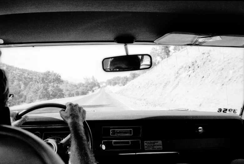 the view from a vehicle with two persons in the passenger seat