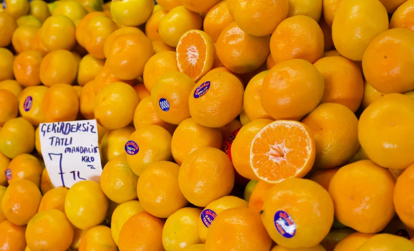 a large pile of oranges with some of them missing