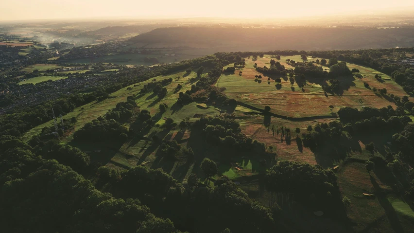 an aerial view shows a patch of land and forest