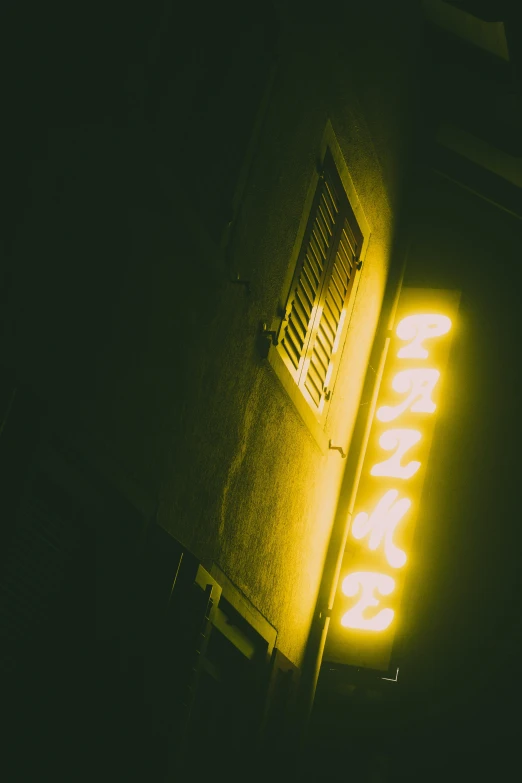 a bright yellow neon sign next to a building