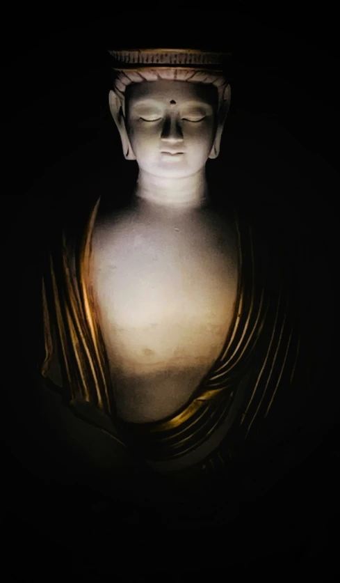 a buddha statue on black back ground