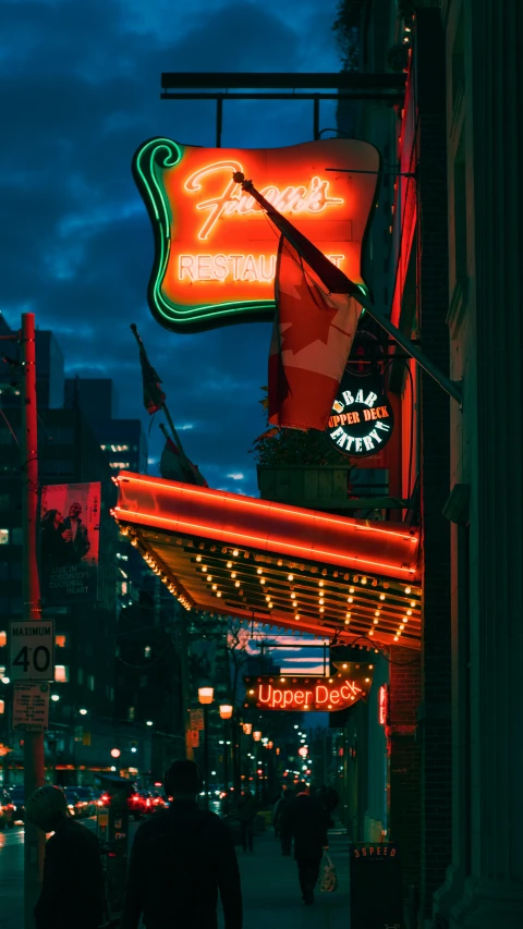 a night view of a neon sign and street scene