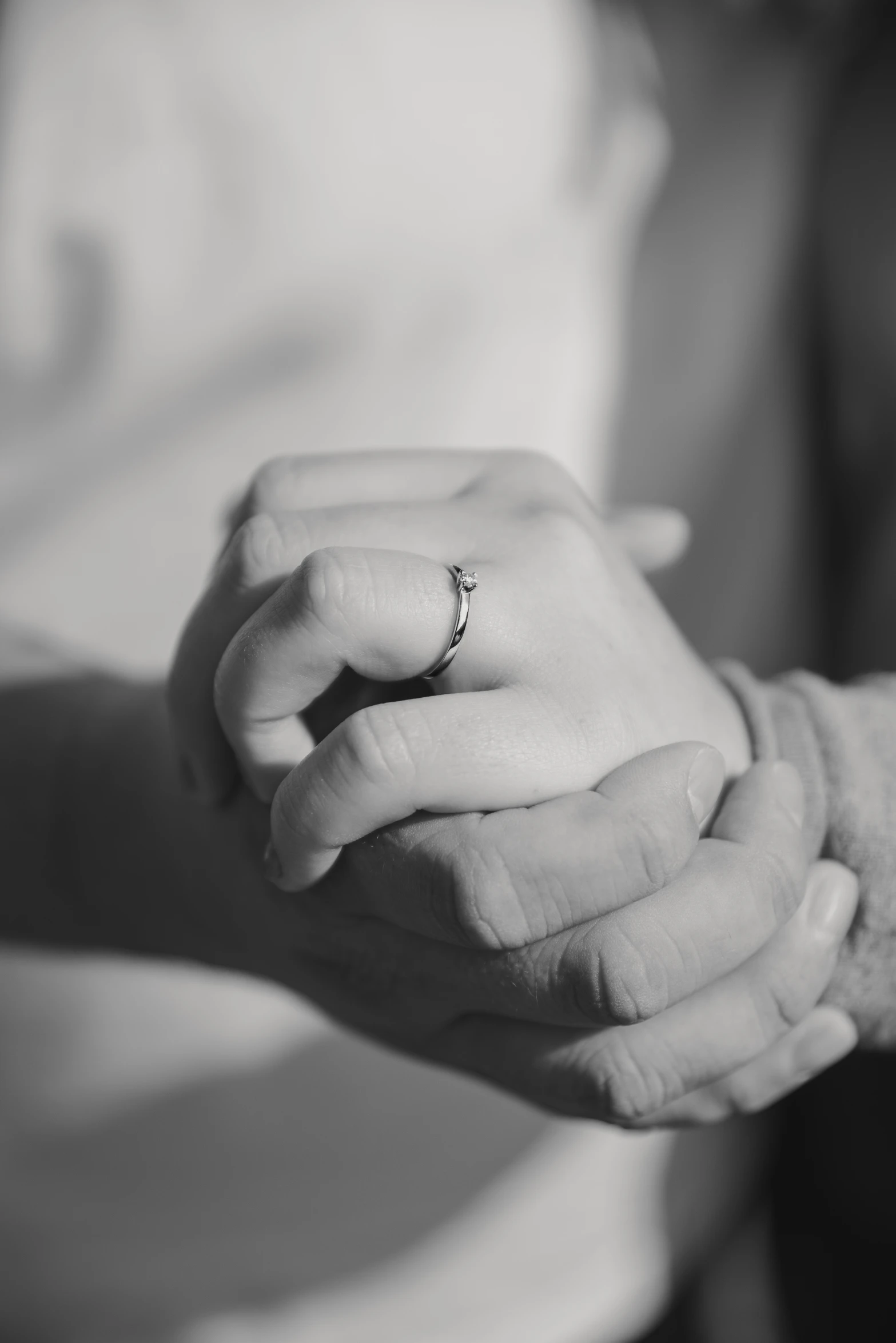 black and white po of a bride and groom holding hands