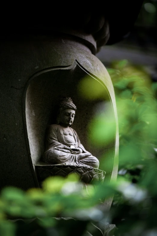 there is a buddha statue sitting on some cement