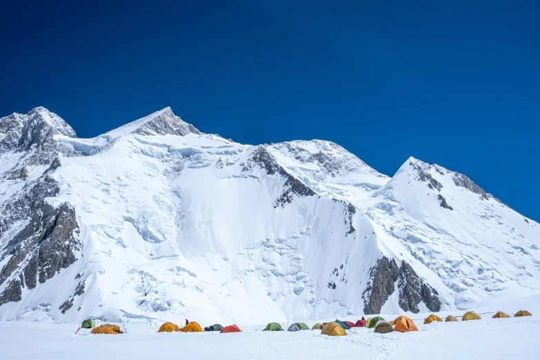 a snow covered mountain in the winter with tentes and tents