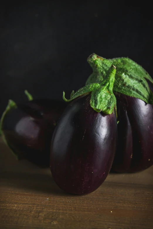 the eggplant is shown with a green stalk sticking out of it