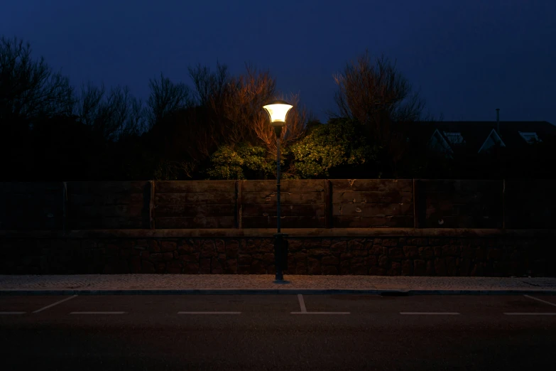 a lamp post in a parking lot at night