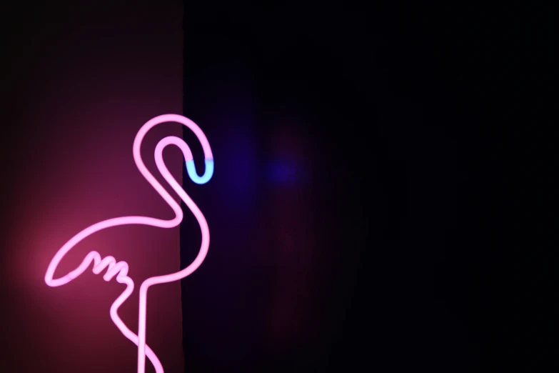 a large neon flamingo with its long neck and head