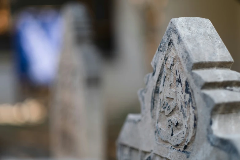 a close up picture of a cement object with its carvings