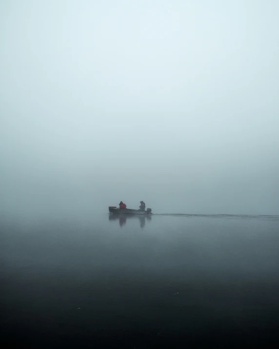 people are in the fog on a boat