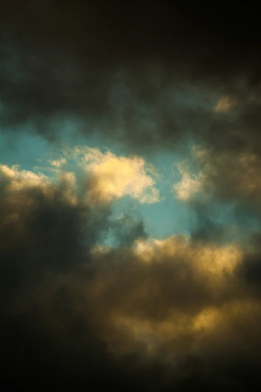 an airplane flying across the sky with a yellow light