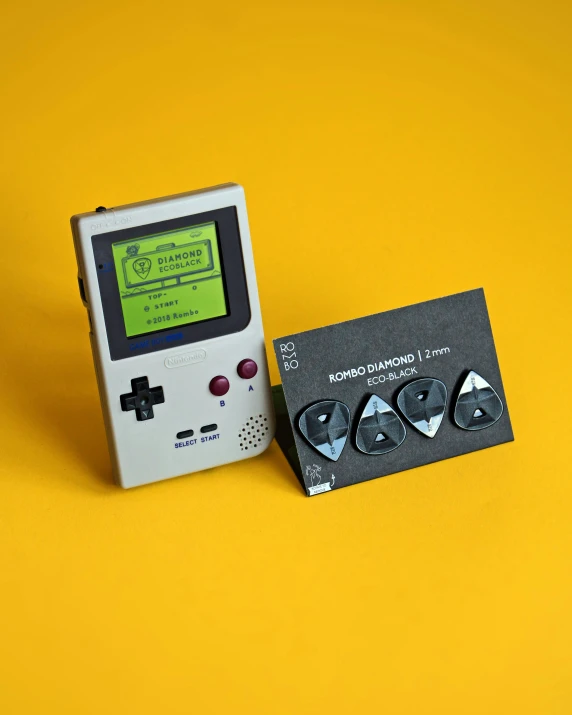 a card with two pieces of gameboy type electronics