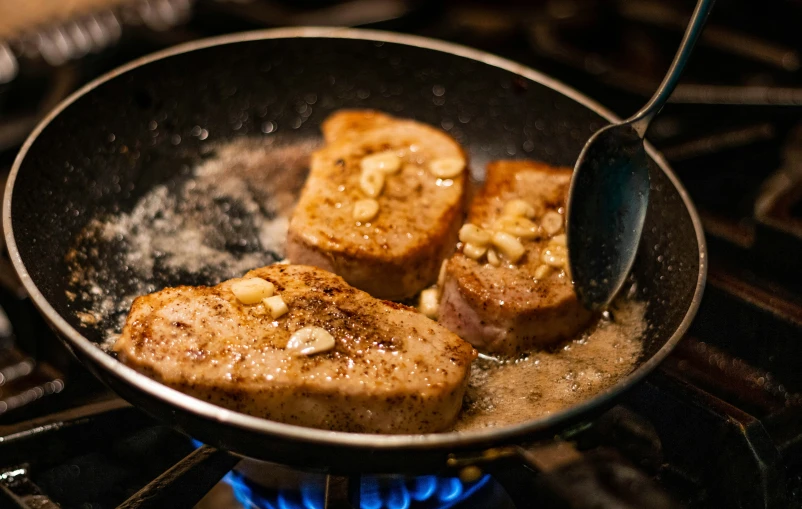 a pan filled with food sitting on top of a stove