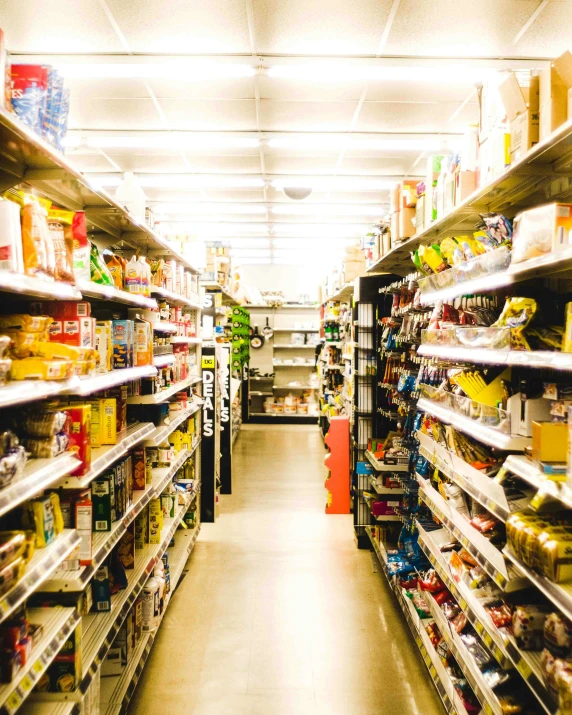 a long aisle that has shelves and shelves filled with food