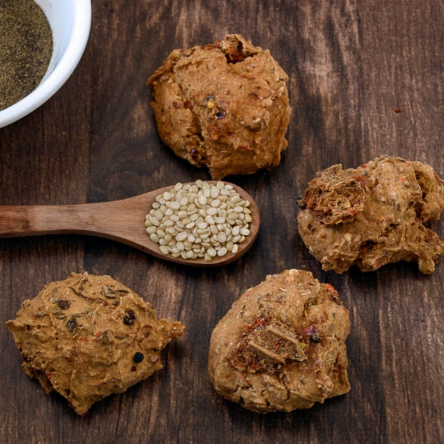 four cookies on a table next to a spoon