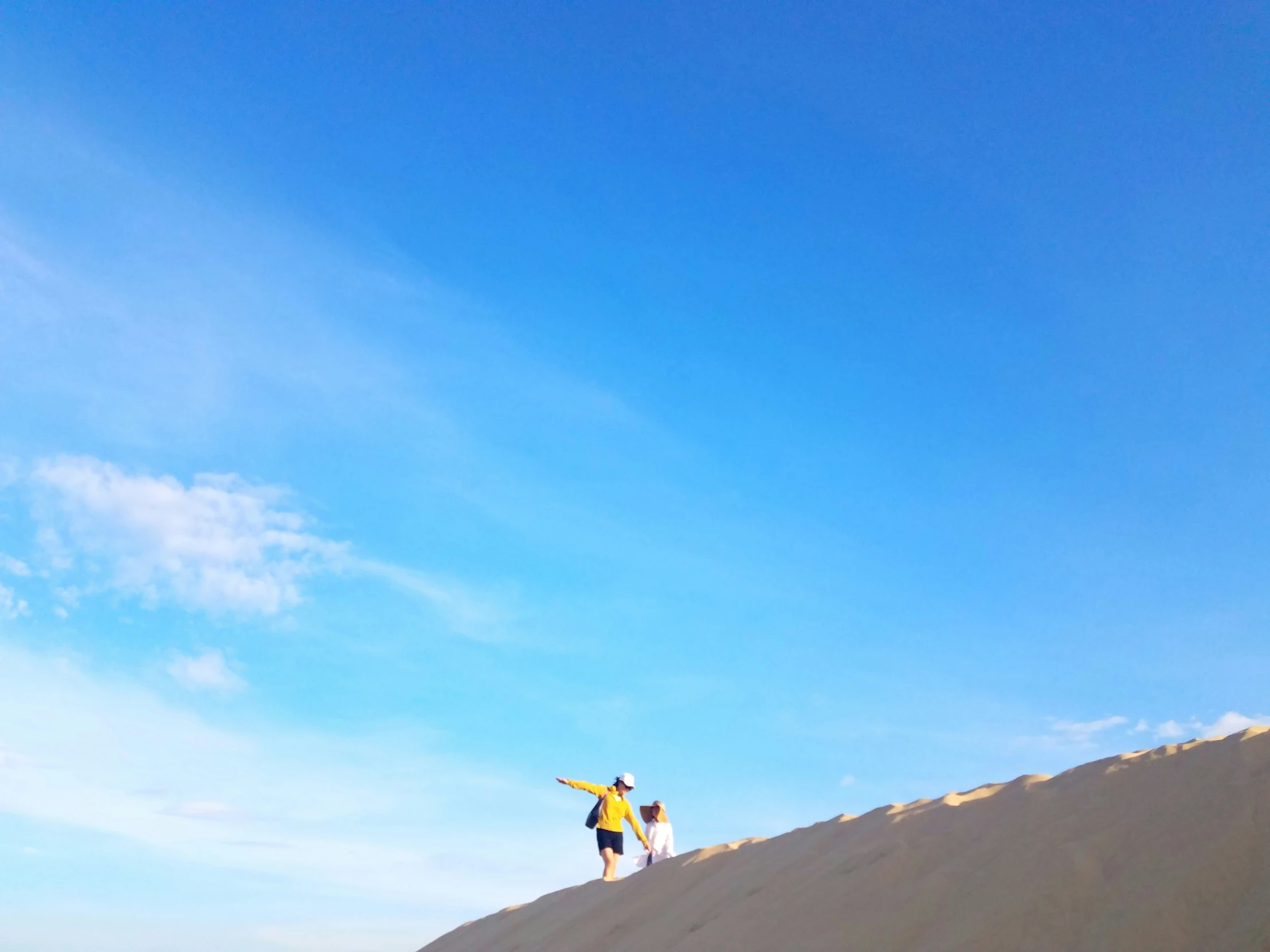 there is a man that is standing on the sand