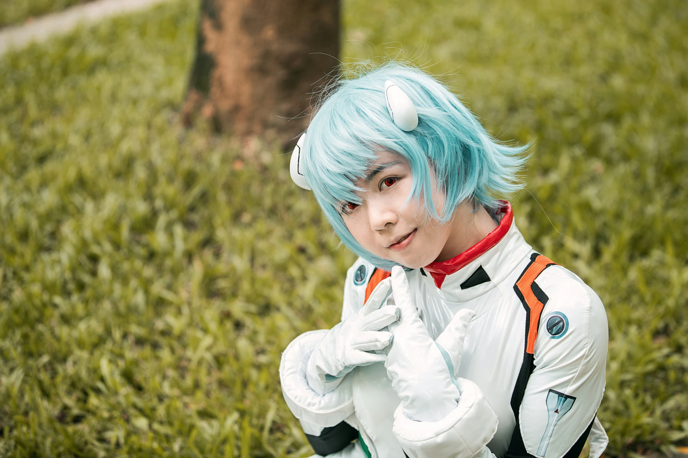 a person in costume with light blue hair and an orange around