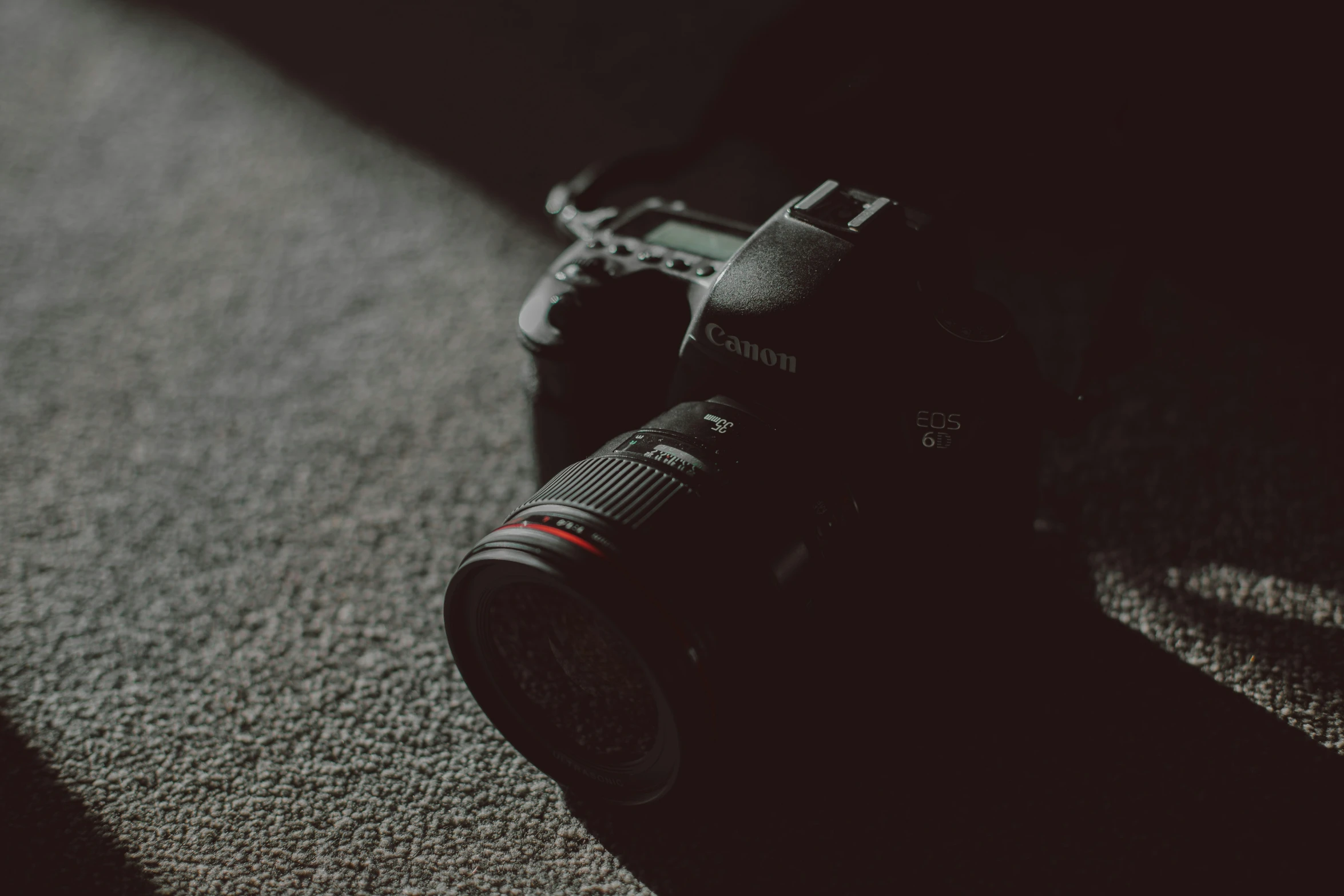 a camera sitting on top of a carpet