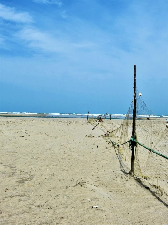 two beach volleyball nets on a sandy beach