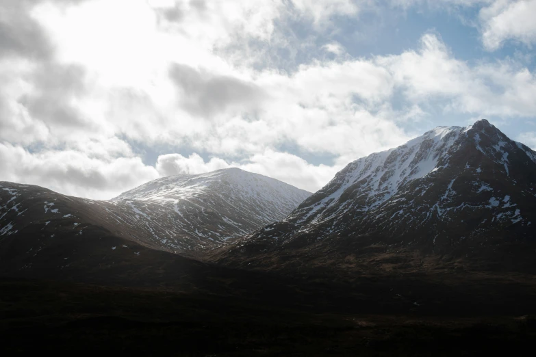 a group of mountain peaks covered in snow