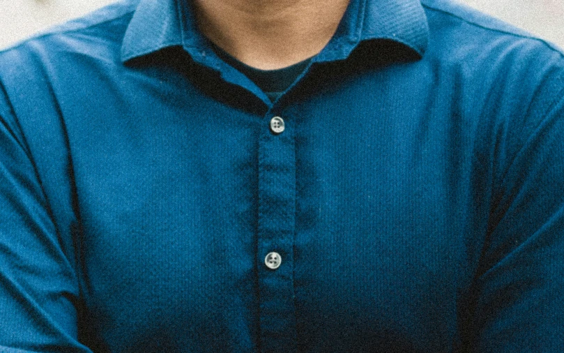 a man in a blue shirt with his arm around him