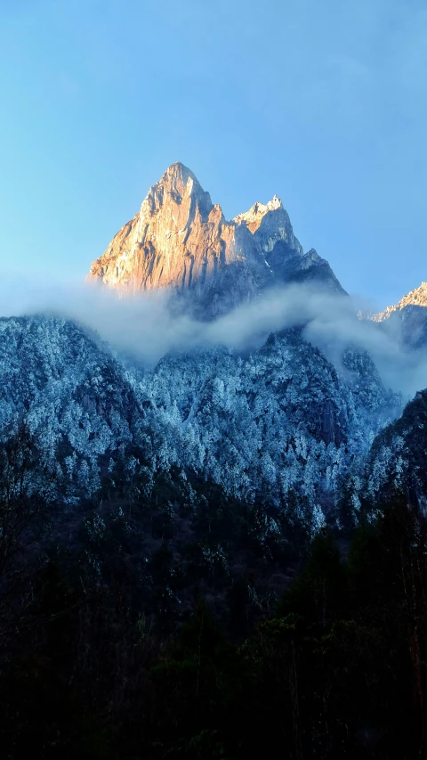 the mountains and clouds are covered by low light