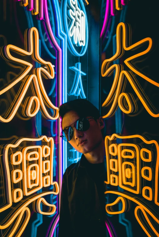 a man is shown standing under neon signs