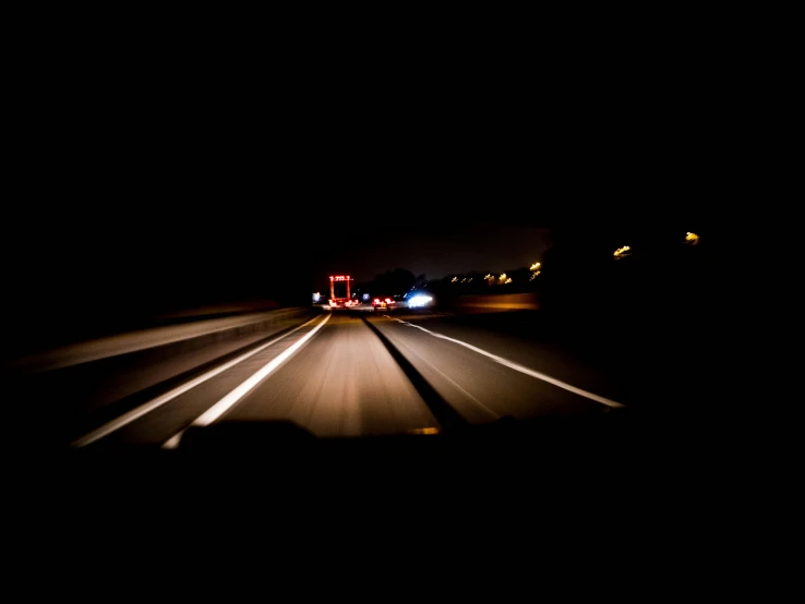 driving with headlights in the dark and a truck moving through