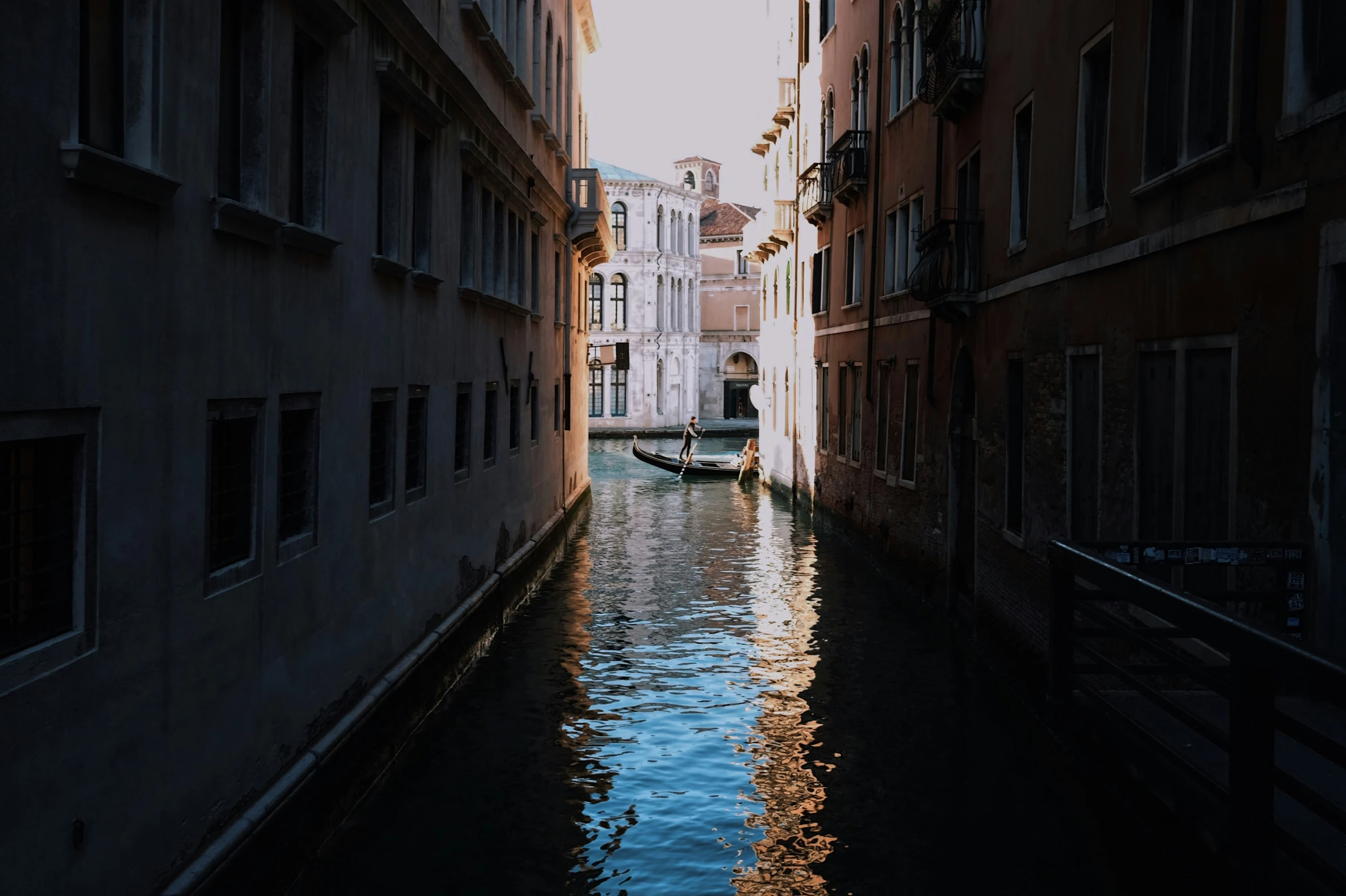 some boats docked near buildings by water