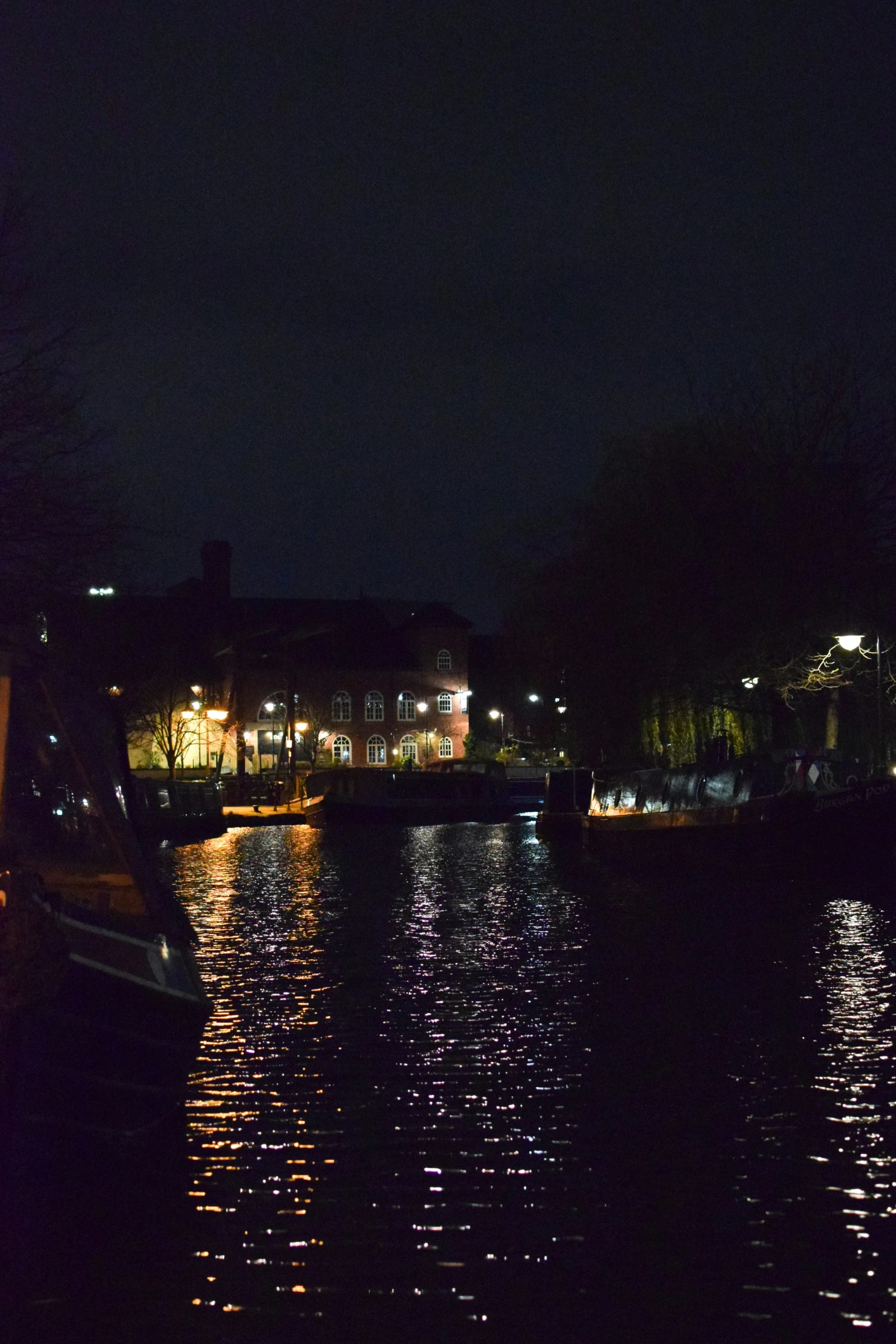 a boat sitting on a river at night