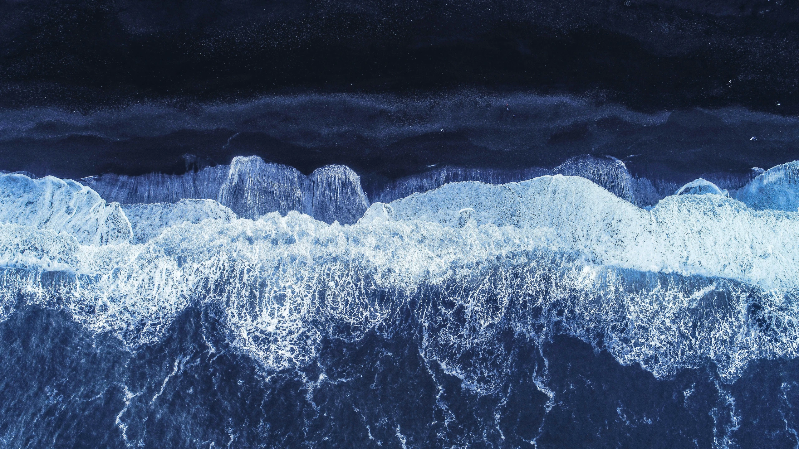 an abstract picture of waves with the moon in the distance