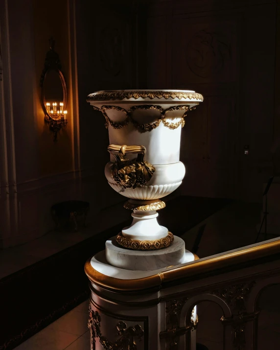 a vase on display in a dimly lit room