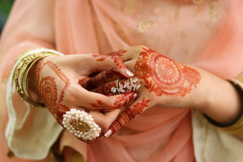 an indian woman wearing a beautiful ring in her hands