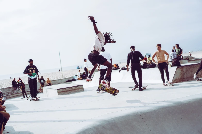 several people on skate boards on a wall