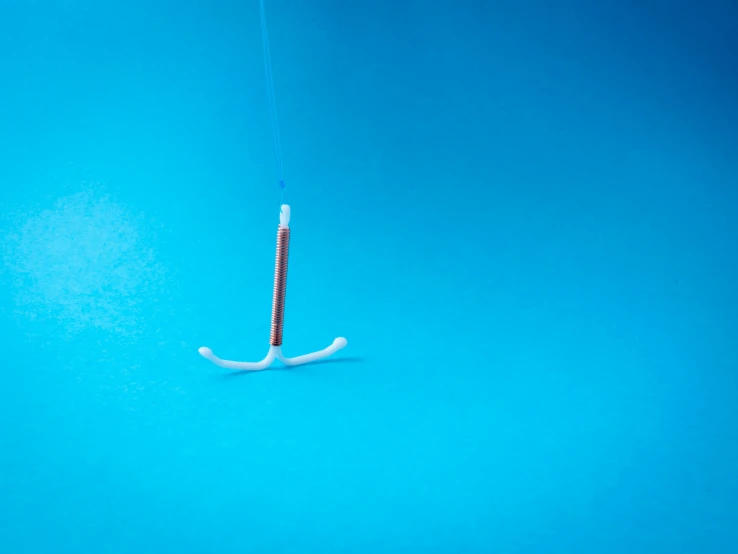 a toothbrush with toothpaste attached to it next to a tooth brush holder