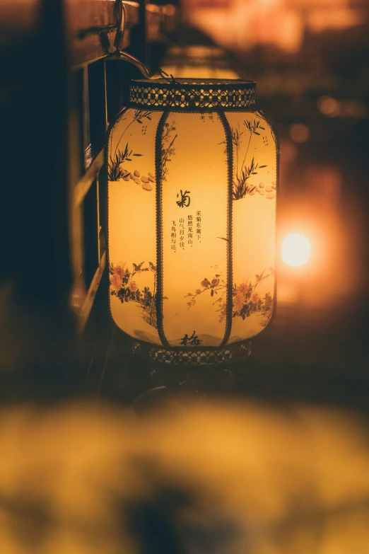 a yellow lantern sitting in a room next to a candle
