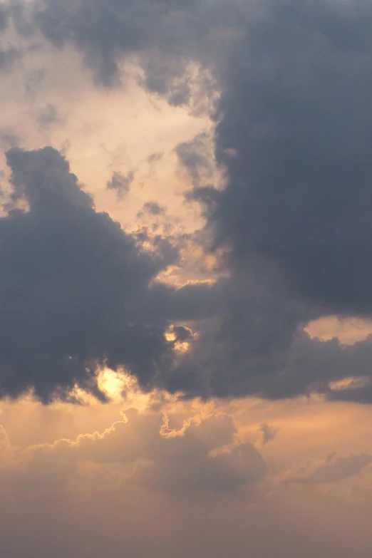 the clouds are moving slowly during the sunset