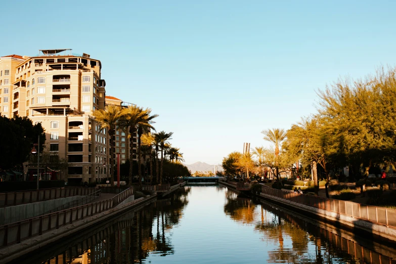 a canal going through the center of some buildings in the background