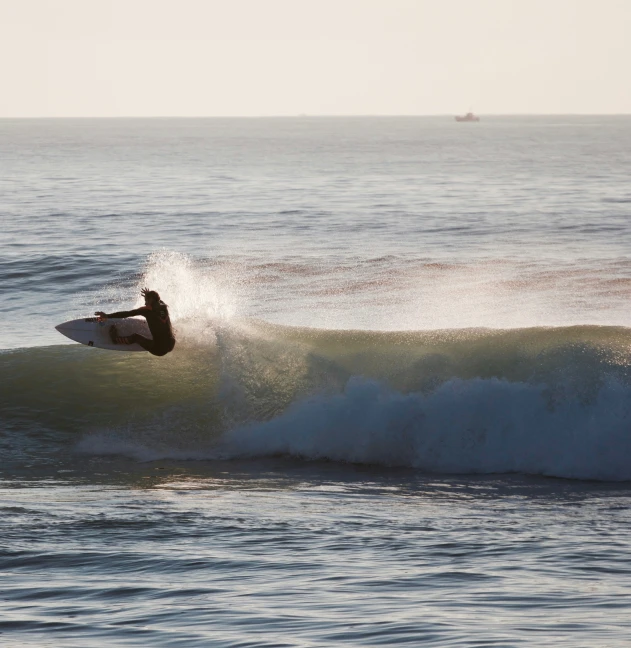 a person on a surf board riding a wave