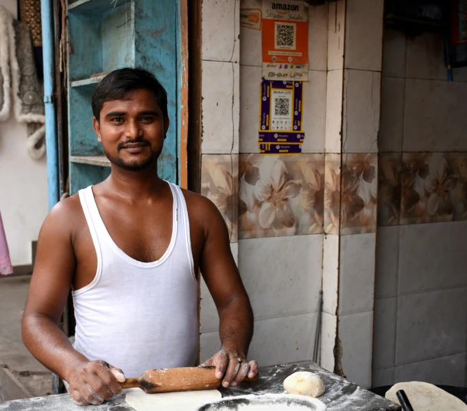 a man standing in front of a kitchen preparing food