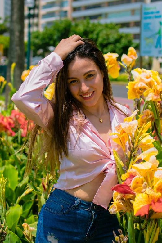 a woman is posing for a po in some flowers