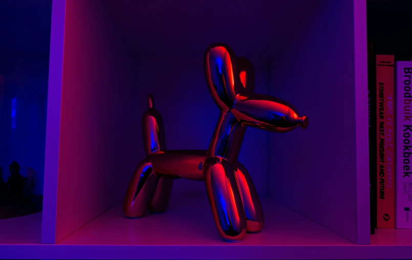 an inflatable dog figure is standing in a pink room