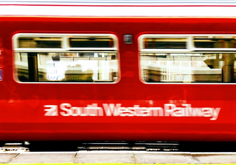 the reflection of an establishment sitting in a train window